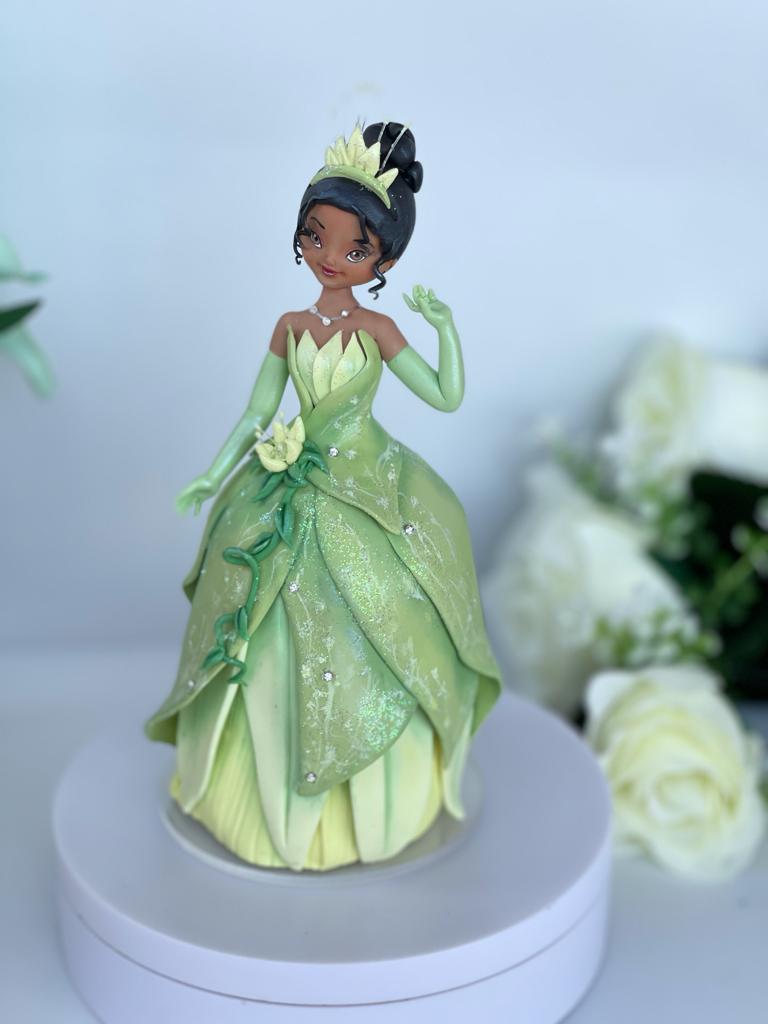 Princess Tiana two tier cake, one tier strawberry, the other tier vanilla.  All decor made by hand by Simply from Scratch! | By Simply From Scratch  est. since 2000 | Facebook